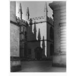 An old buidling in Oxford with early morning sun projecting shadows of ornate pinnacles onto stone walls